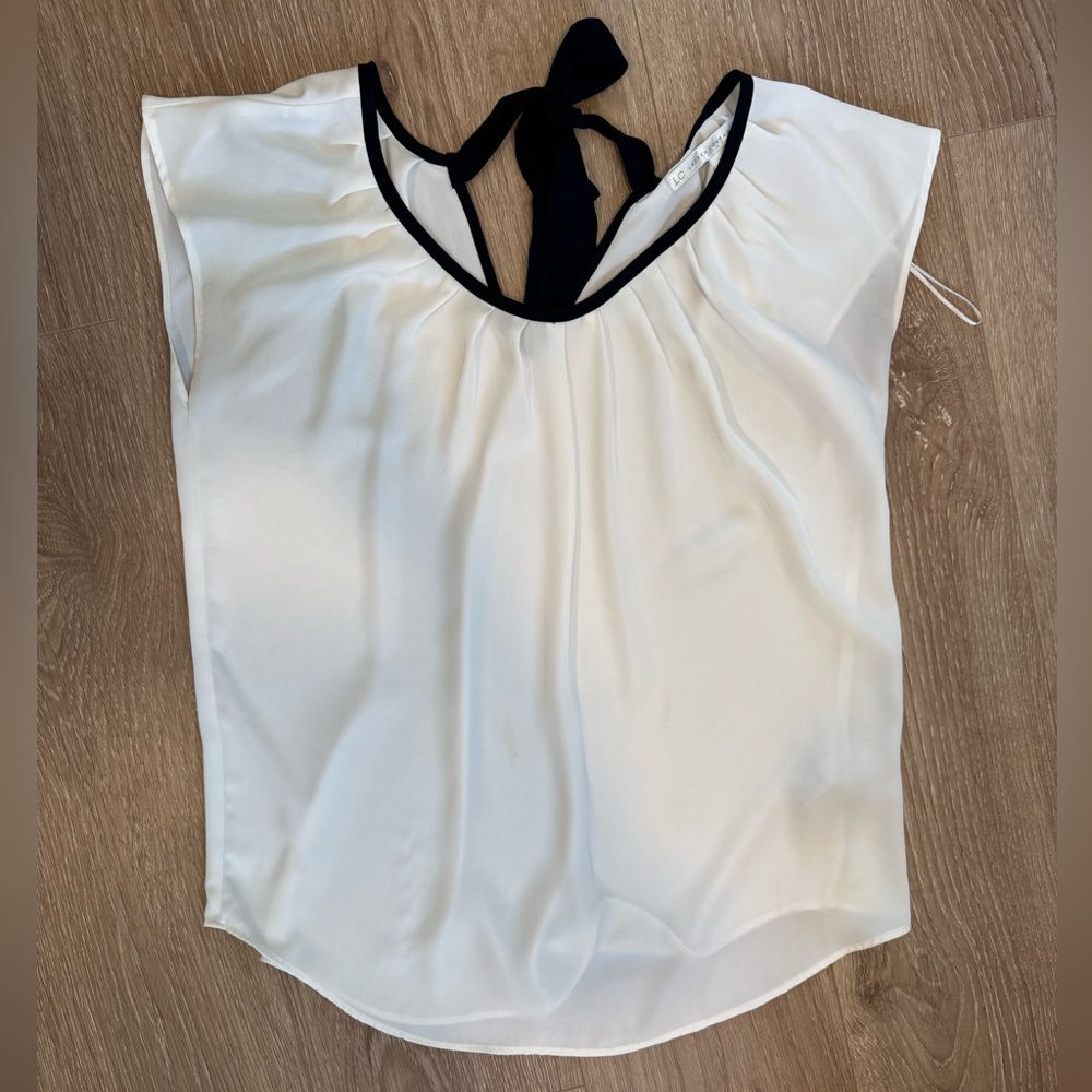 Elegant White Sleeveless Top with Black Trim